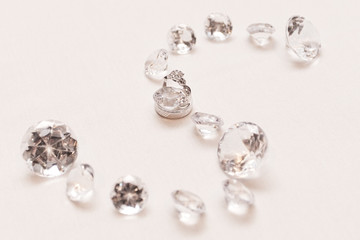 Diamond shaped S with white gold rings in the middle 