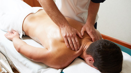 a massage therapist makes a man massage spa treatment health