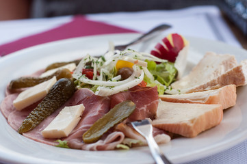 closeup of traditional alsatian salad with sausage and cheese