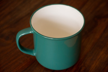 Blue china mug on a table. Isolated.