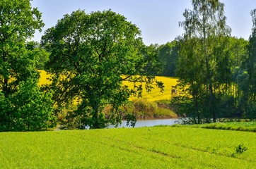 Obraz premium Beautiful spring landscape. Colorful hills above the river in the countryside.