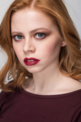 beautiful sexy redhead girl with bright makeup