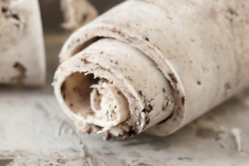 Roll ice cream is made by hand on the freezer. Sweet dessert made from natural berries and ingredients.