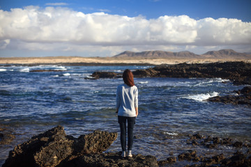 Lonely woman on beautiful ocean beach