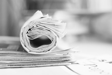 Pile of newspapers, folded and stacked journals with news. Side view, selective focus    