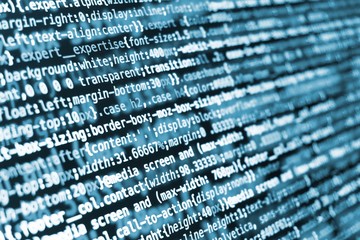 Compressed CSS programming code on screen in blue tones