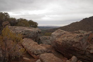 Fototapeta na wymiar Wilpena Pound South Australia, view across wilpena gap with boulders in foreground