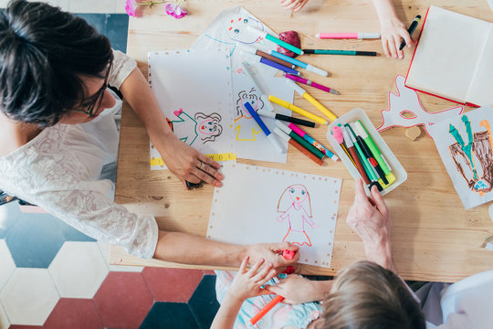 ovierhead view family indoor drawing with coloured pencil - enjoyment, creativity, leisure concept