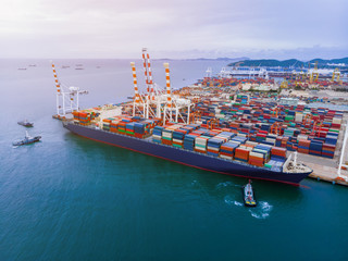 Cargo container ship in the cargo international yard port carrying full load ready to export tank.