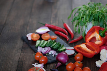 vegetables for salad on an old wooden table.