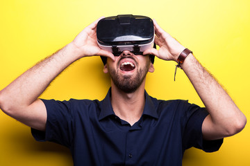 Young man in blue shirt enjoying virtual reality for the first time