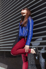 Beautiful and stylish young girl in stylish clothes outdoors in sunny weather