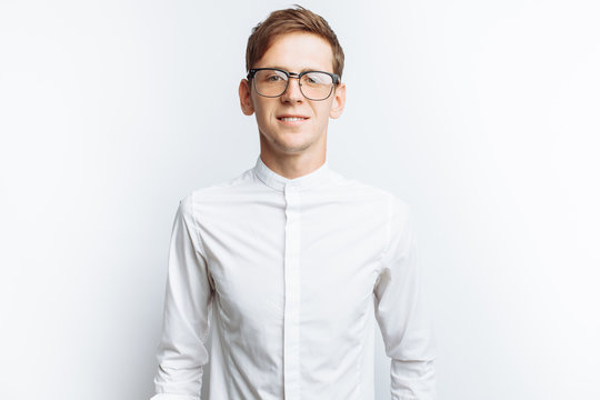 Portrait of young attractive guy in glasses, in white shirt, isolated on white background, for advertising, text insertion