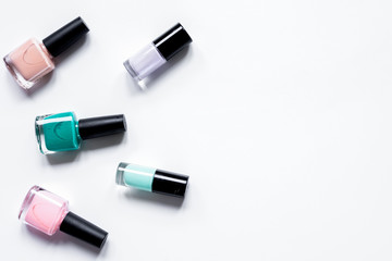 Obraz premium collection of nail polish on white desk background top view mock