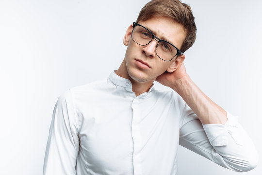 Portrait of young attractive guy in glasses, in white shirt, isolated on white background, for advertising, text insertion