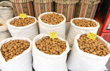 Walnuts in a white bag at the market.
