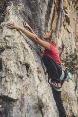 A Woman Climbing a Rock