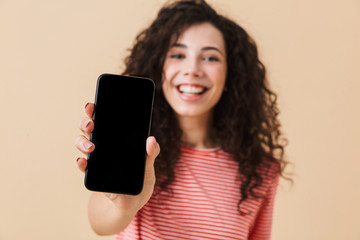 Cheerful young girl with dark curly hair