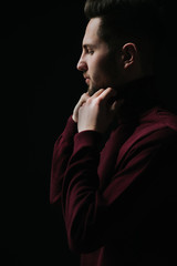 Portrait of a young man. Male studio portrait with cinema light and dark backdrop.bachelor