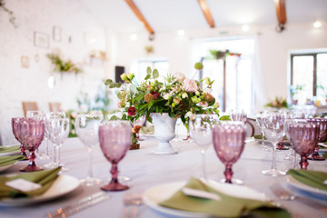 Wedding banquet, loft style, served tables with flowers and lots of greenery