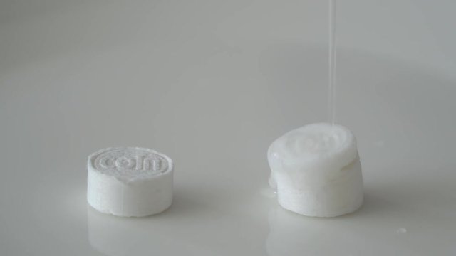 compressed coin tissues absorbing water