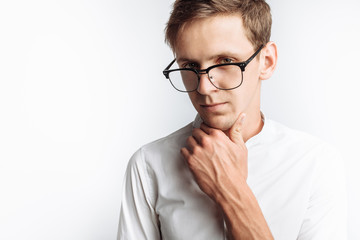 Portrait of young attractive guy in glasses, in white shirt, isolated on white background, for advertising, text insertion - obrazy, fototapety, plakaty