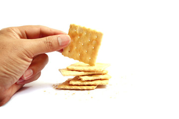 healthy adult hand hold a cracker on white background isolated