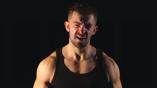 Fit Athlete Working Out Biceps at the gym on black background