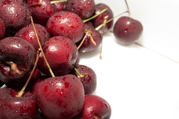 Fresh cherry. Close up of pile and ripe cherries with stalks and leaves
