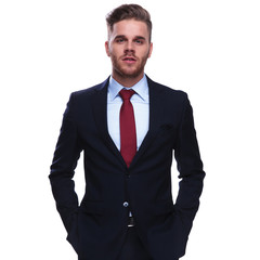 portrait of elegant attractive businessman with hands in pockets