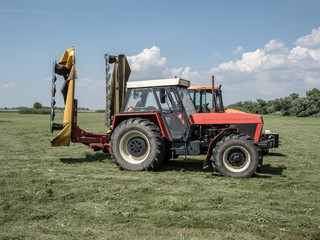 Tractor with mowing machine. Slovakia, June 2018.