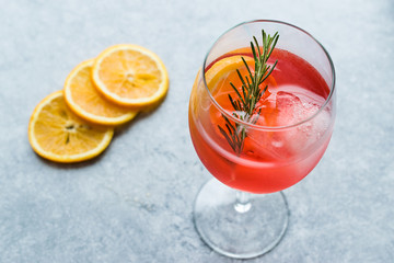 Aperol Spritz Cocktail with Orange Slice, Rosemary and Ice.