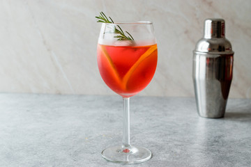 Aperol Spritz Cocktail with Orange Slice, Rosemary and Ice.