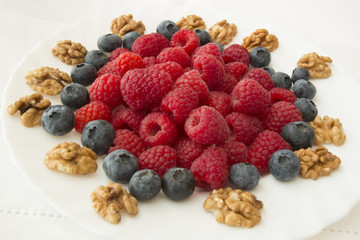 raspberry and blueberries on white background