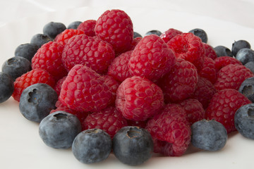 raspberry and blueberries on white background