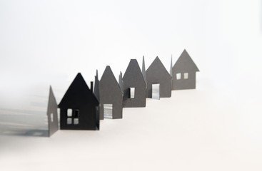 Little houses made of paper combined in line. Abstract background, property concept
