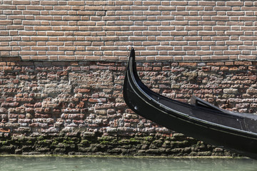 Detail gondola boat, canal and ancient wall. © joan_bautista