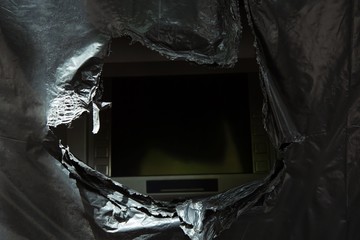 atm machine broken see the dark screen in black bag trash. Concept Poor economic bad financial...