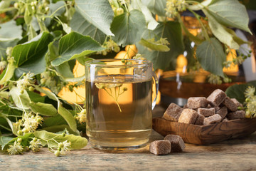 Glass of linden tea with brown sugar .
