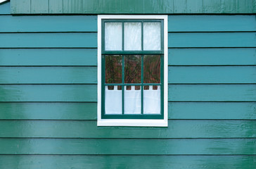 old dutch window on green background