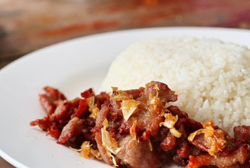 Fried pork with garlic topped with rice