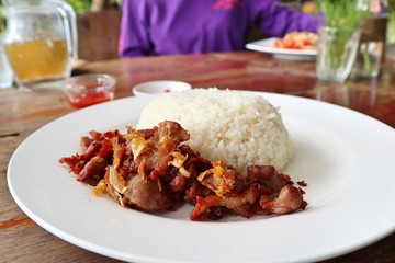 Fried pork with garlic topped with rice