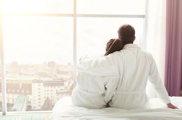 Morning of happy young couple resting in hotel room - obrazy, fototapety, plakaty