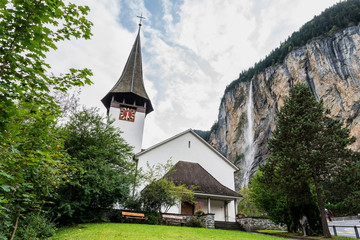 Fototapeta na wymiar Waterfall in the village of Lauterbrunnen near Interlaken in the canton of Bern in Switzerland