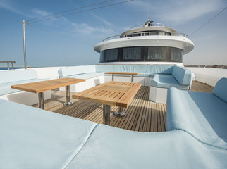Table and chairs on deck of a luxury motor yacht