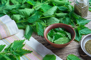 a bunch of fresh nettle on a wooden table