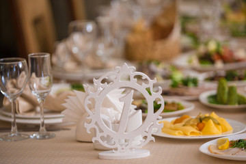 Closeup of served banquet table. Number one card stands on the table