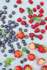Mix of fresh juicy berries on blue background, top view