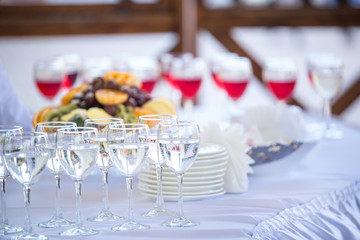 Glasses and fruits on the served table outdoors. Catering