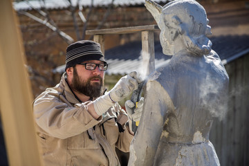 Renovator is engaged in the restoration of the statue